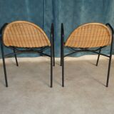 Pair of chairs / vintage armchairs in rattan and black lacquered metal