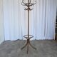 Vintage bentwood coat rack in Thonet style / Dark wood coat rack with shadow.