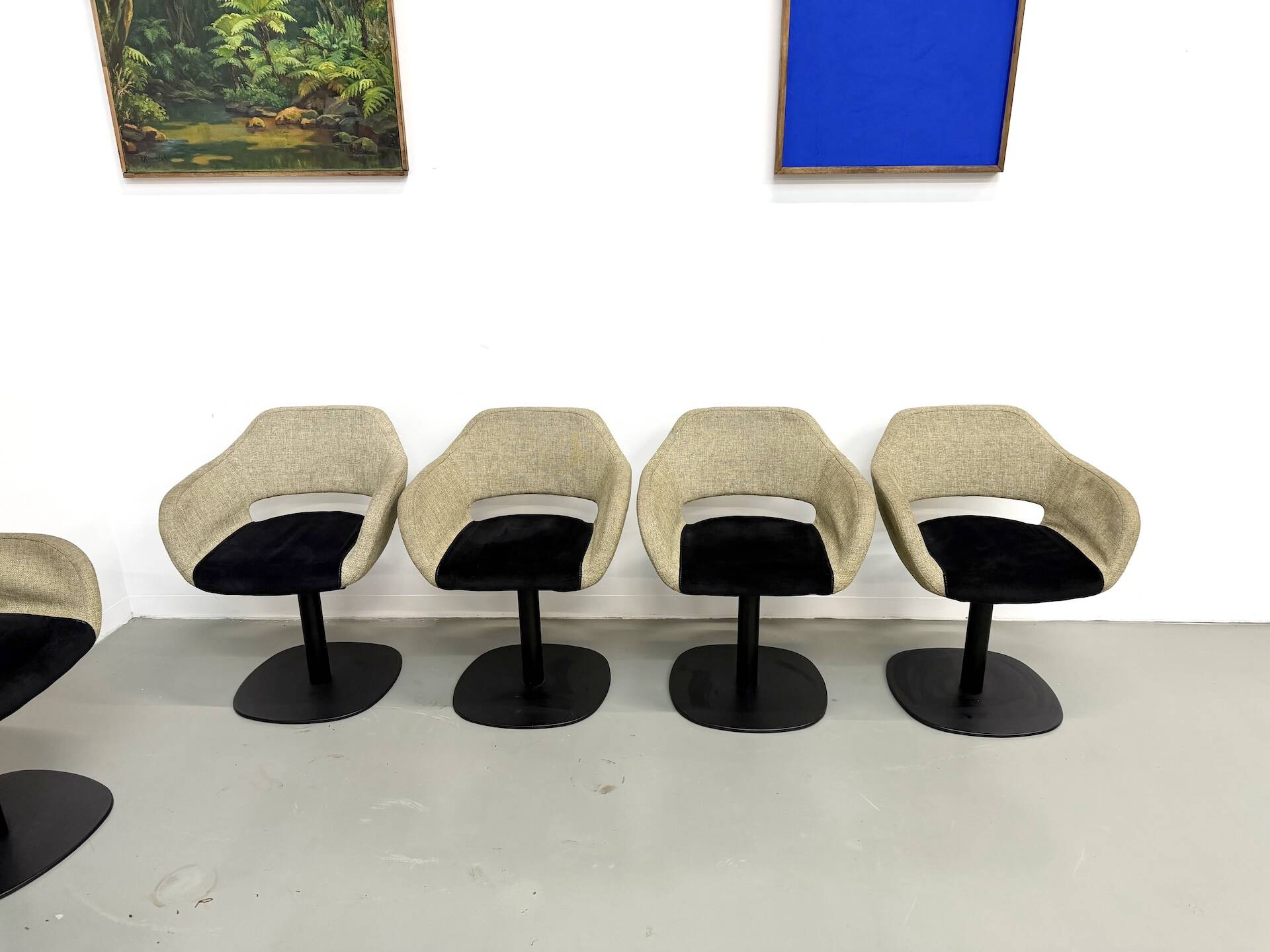 Series of six swivel chairs with an organic shell, patterned fabric and base.