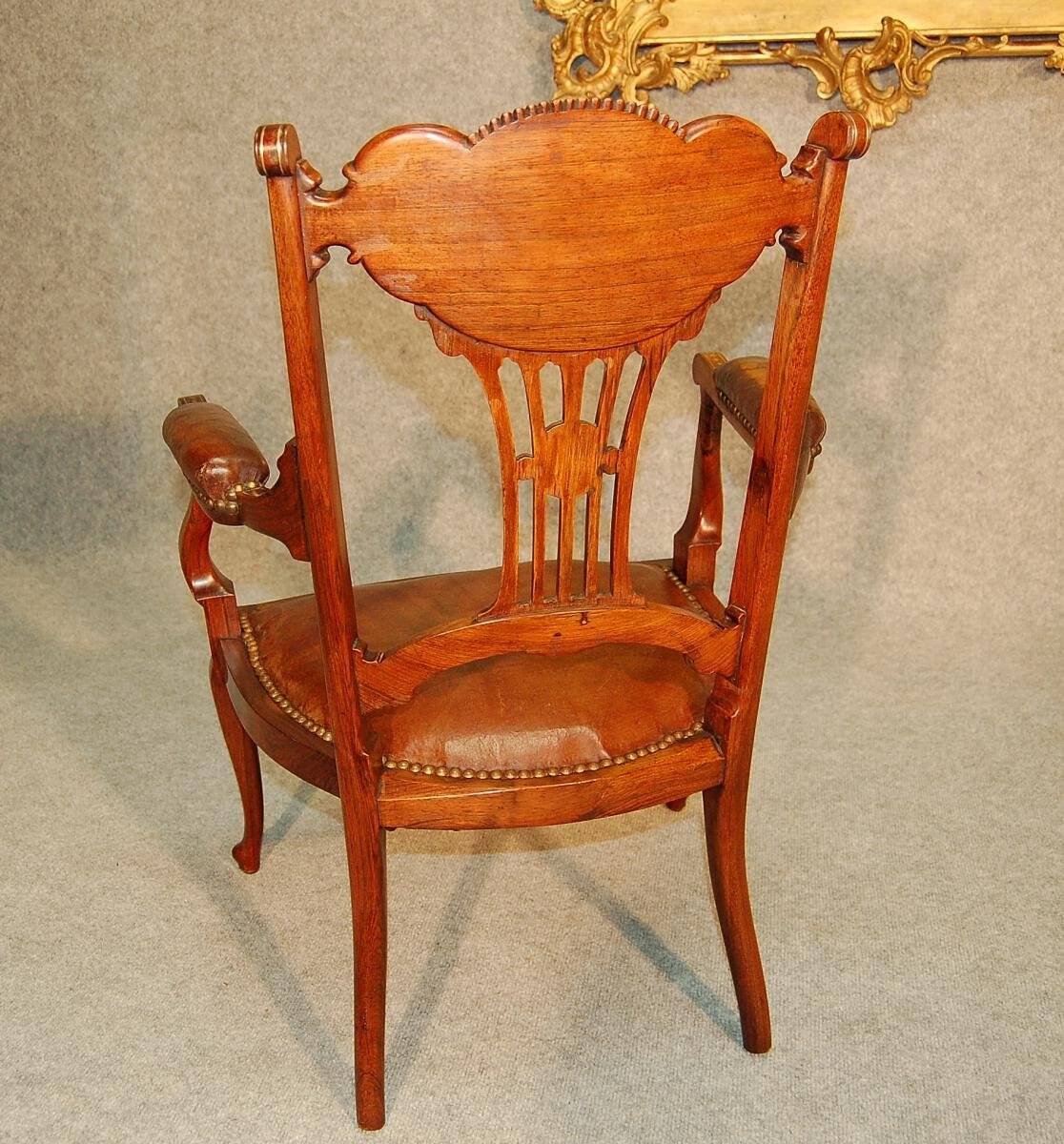19th century armchair in leather and rosewood inlaid with brass and rosewood
