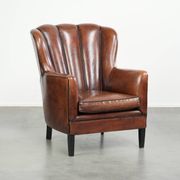Unique sheepskin armchair with warm deep colours finished with black piping