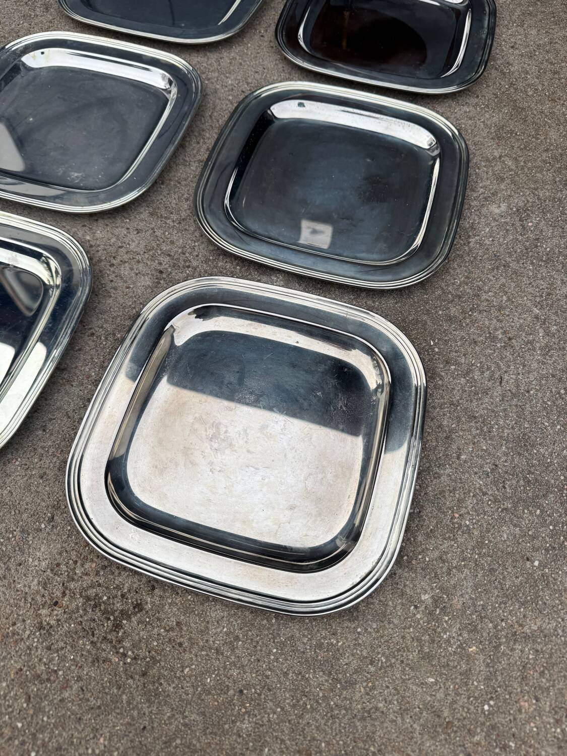 Silver-plated metal underplates from the 1980s.