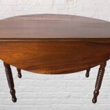 Oval walnut table with flaps