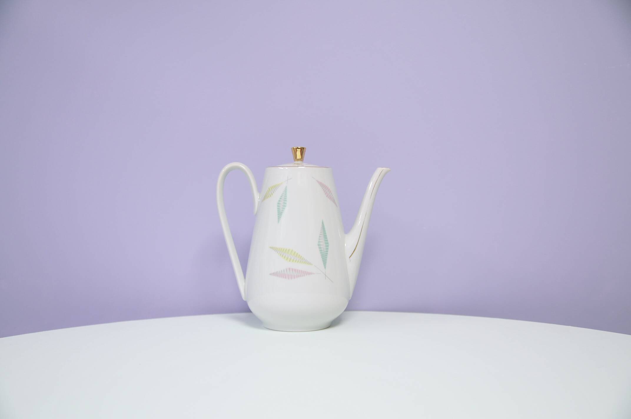 White teapot with pastel flowers