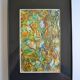 Framed abstract painting under glass