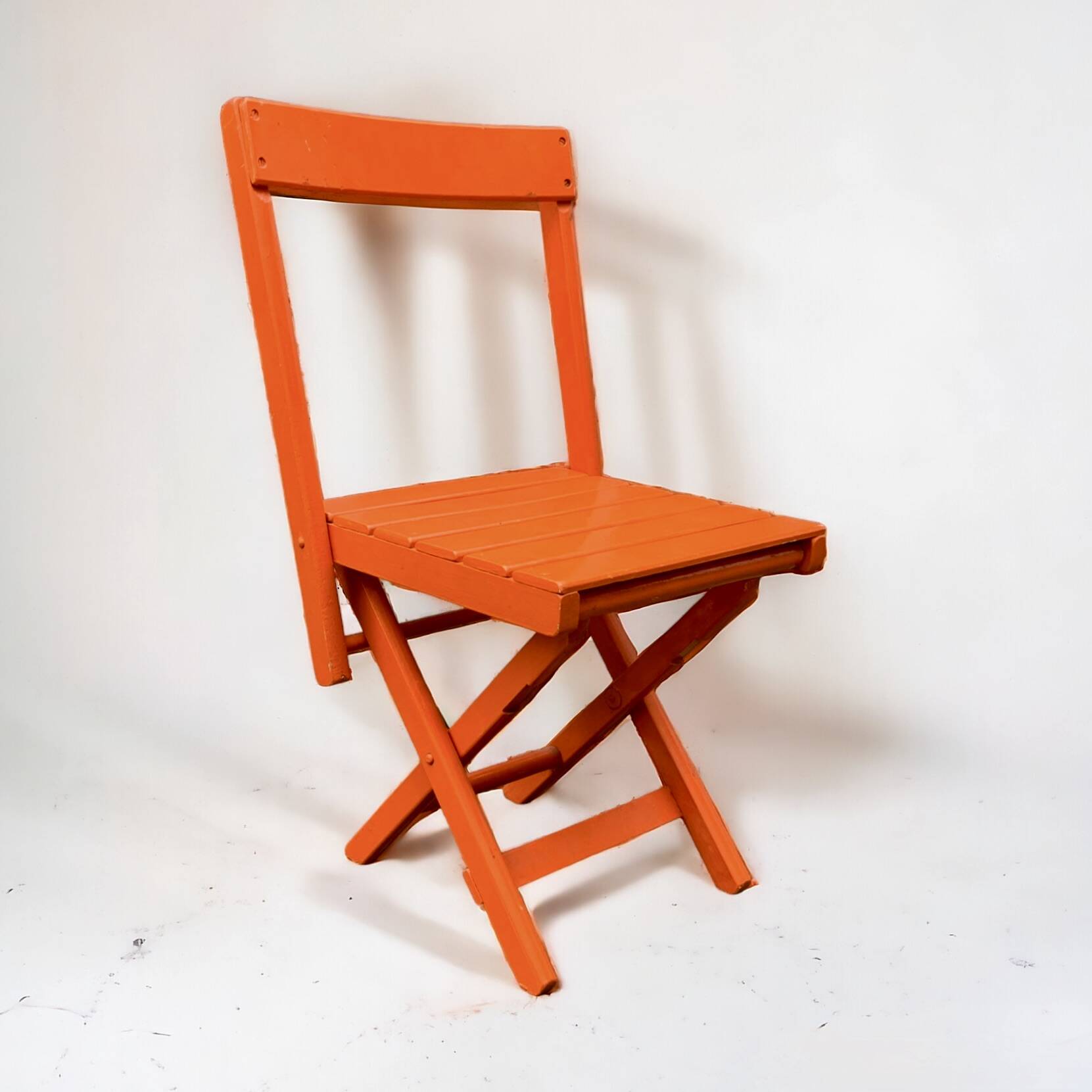 Vintage folding chair in orange painted wood