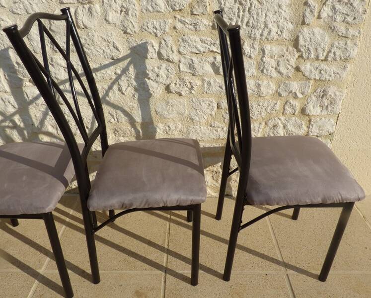 4 black metal chairs with high backs and gray suede tops