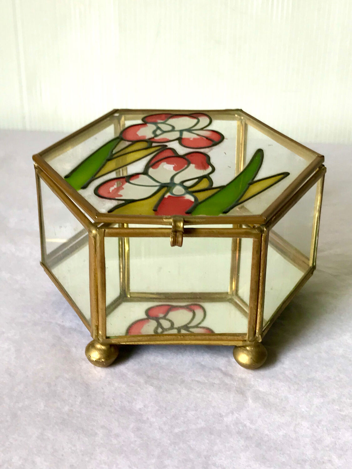 Glass box and hexagonal brass enamelled floral decoration