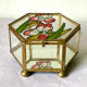 Glass box and hexagonal brass enamelled floral decoration