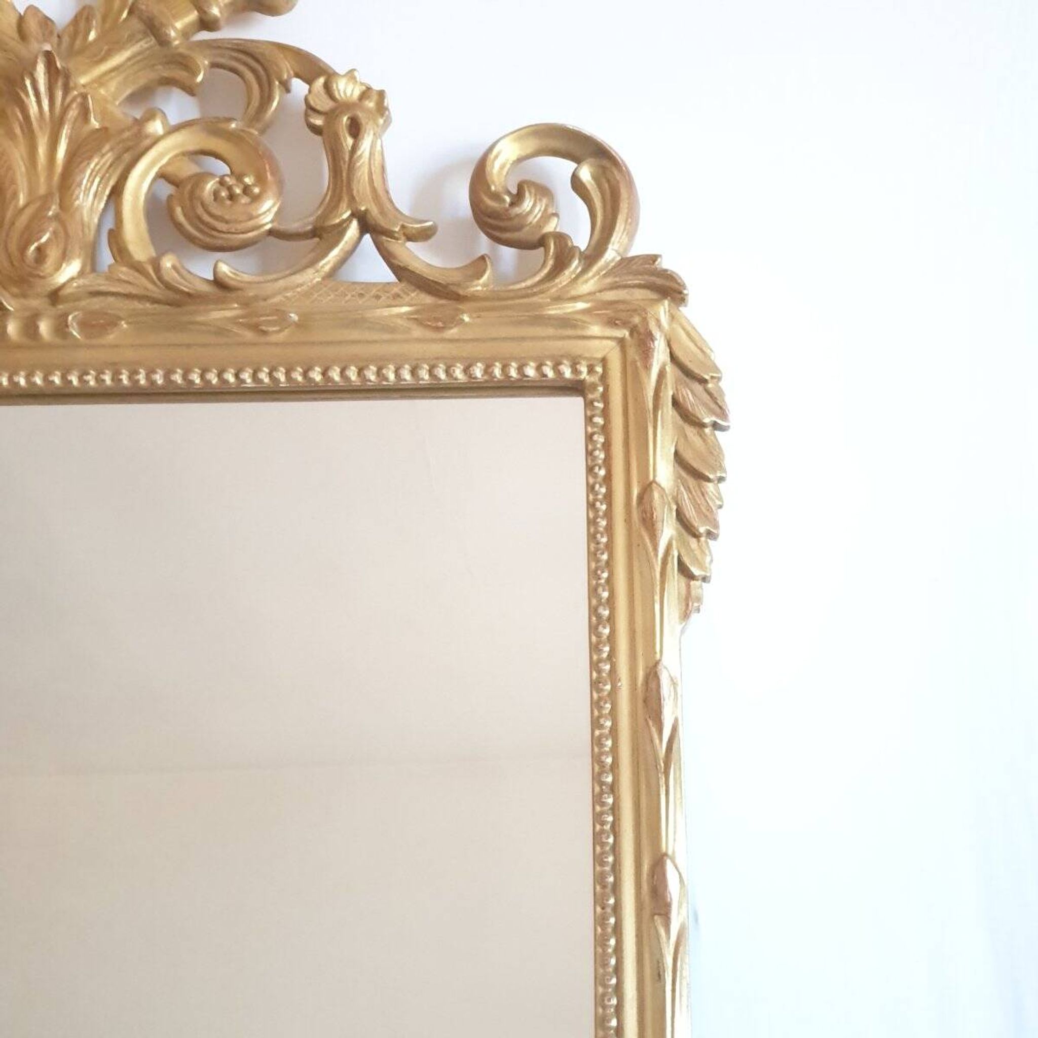 Golden mirror in the Louis XVI style from the 20th century.