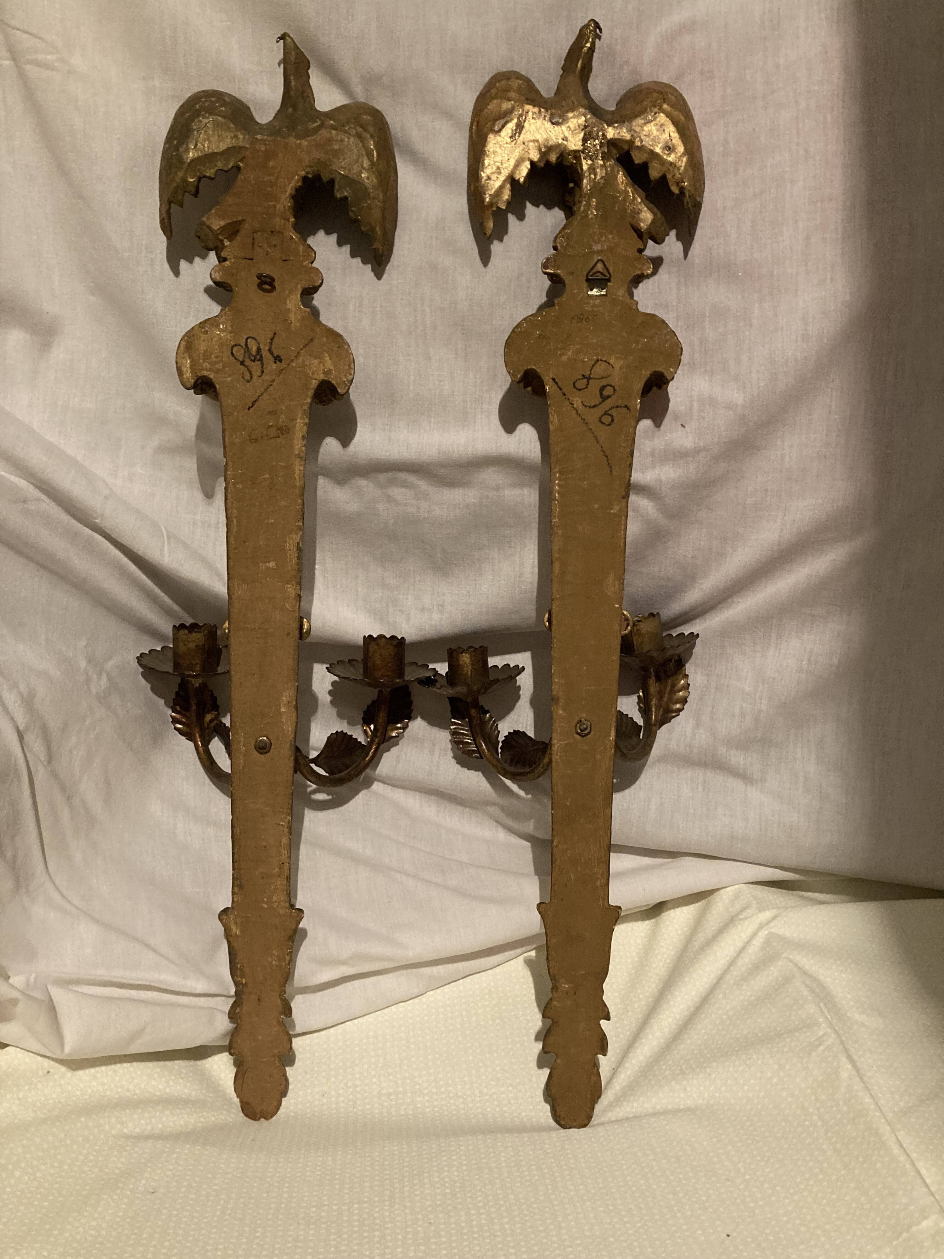Pair of candle holders in wall, eagle pattern in gilded wood and brass