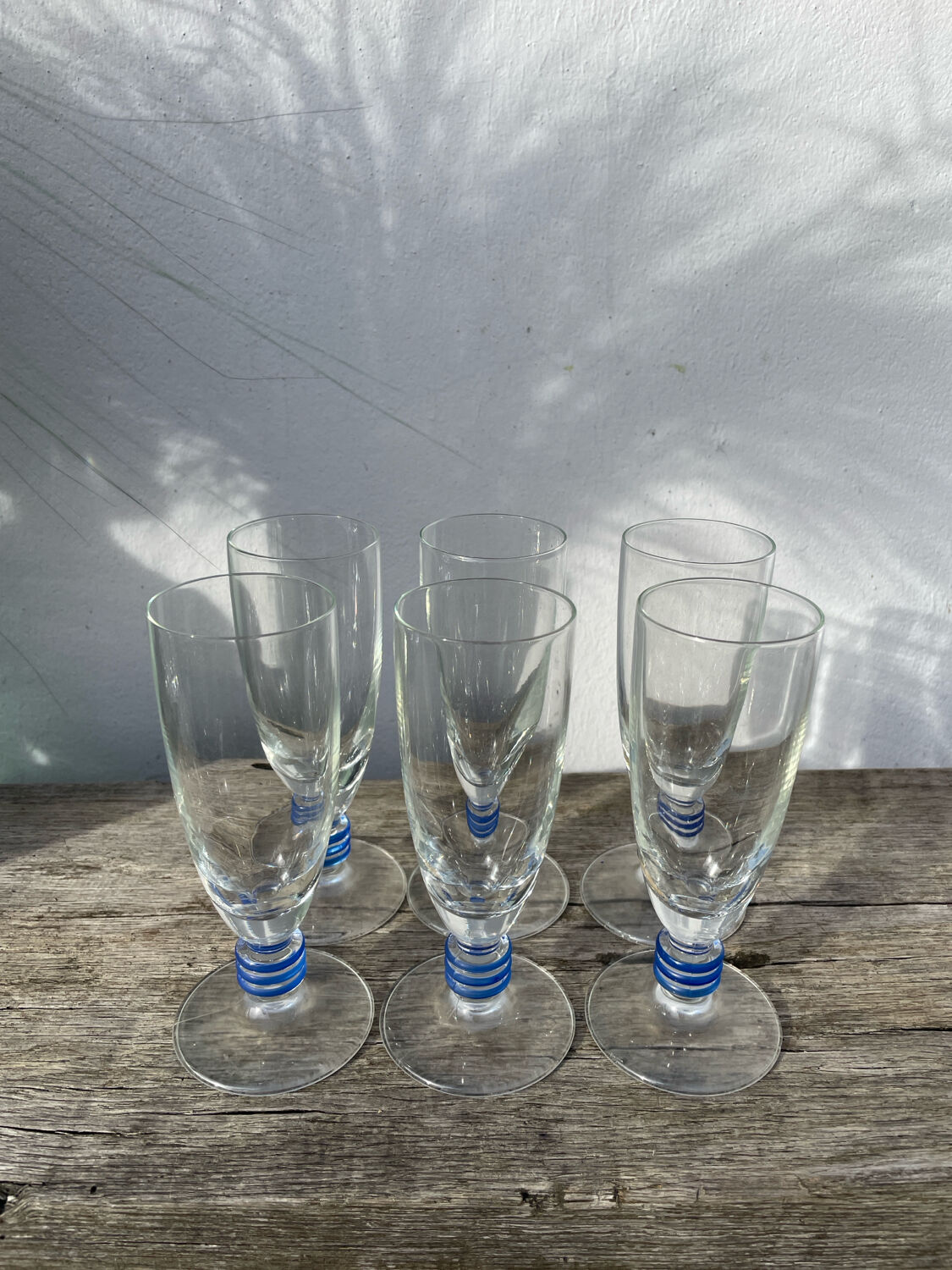 6 clear champagne flutes with blue stems, designer style