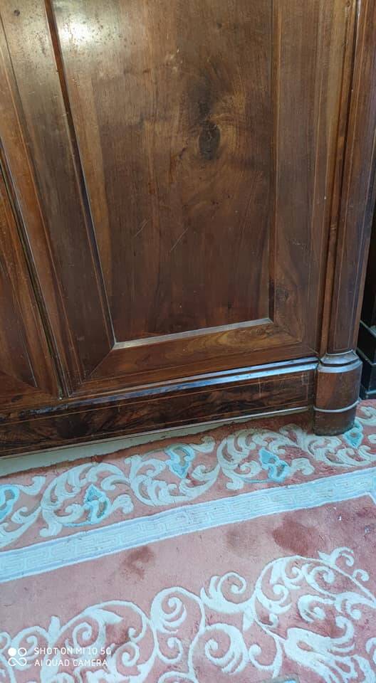 A walnut wardrobe with marquetry and boxwood stringing, dating from the Consulate period, circa 1810.