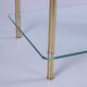 Hollywood Regency side table with gold-colored legs