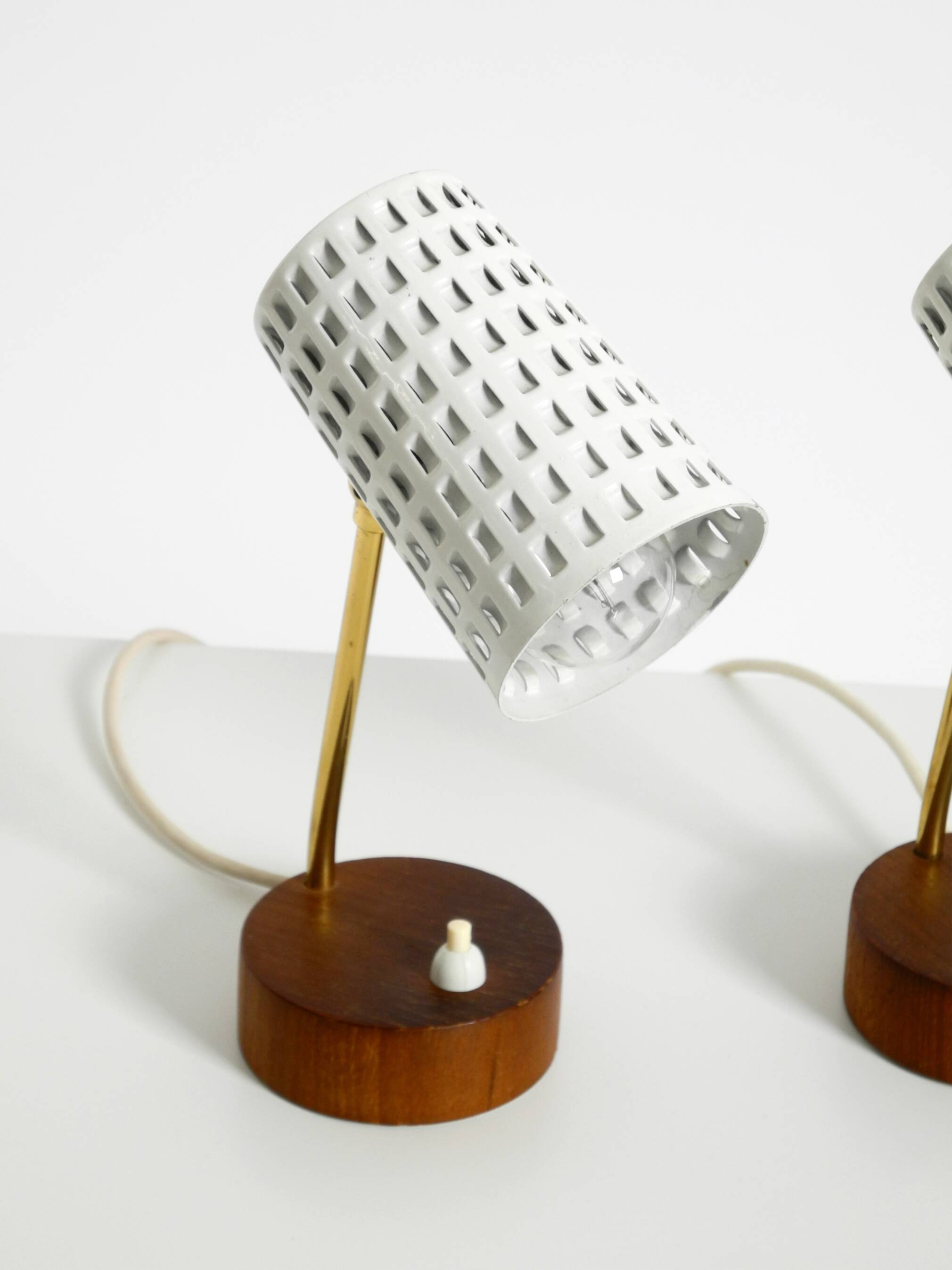 A pair of mid-century modern bedside lamps with perforated metal shades