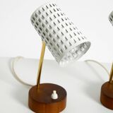 A pair of mid-century modern bedside lamps with perforated metal shades
