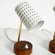 A pair of mid-century modern bedside lamps with perforated metal shades