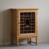Scandinavian wardrobe in natural oak with a glass front.