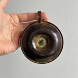 Small antique candle holder in patinated metal