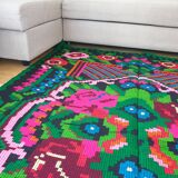Handwoven colorful Romanian carpet, green and black background with gorgeous colorful flowers