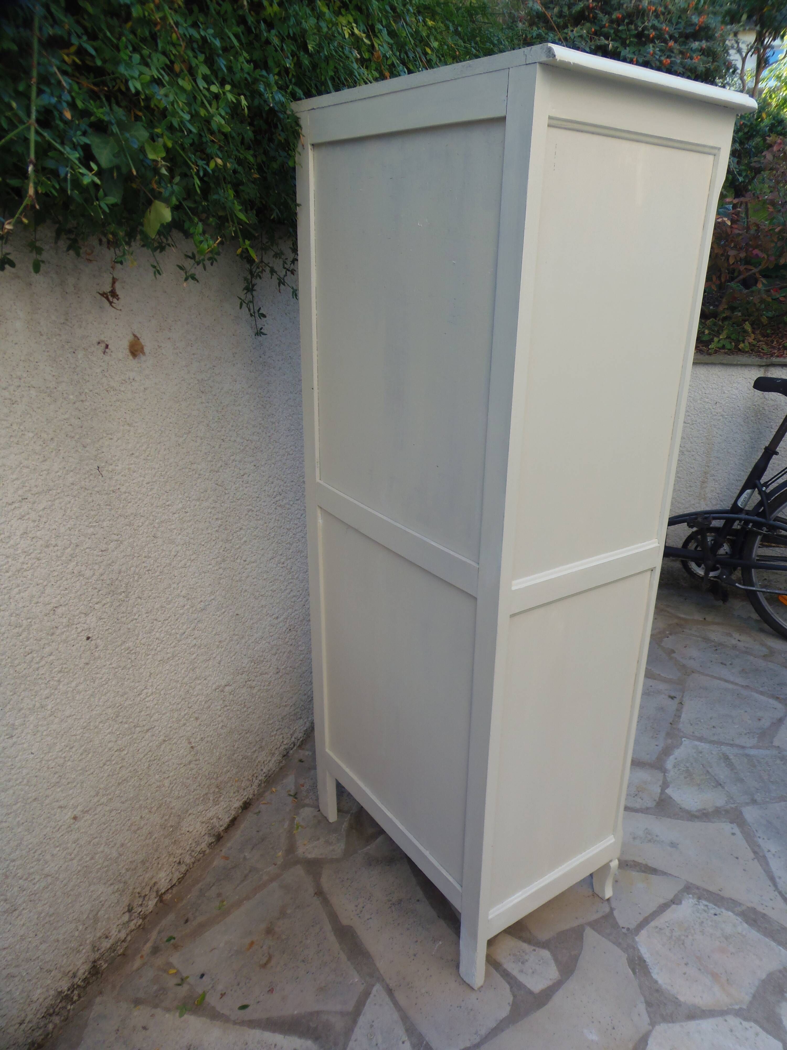Vintage beige wardrobe made of wood and jute fabric.