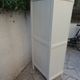 Vintage beige wardrobe made of wood and jute fabric.