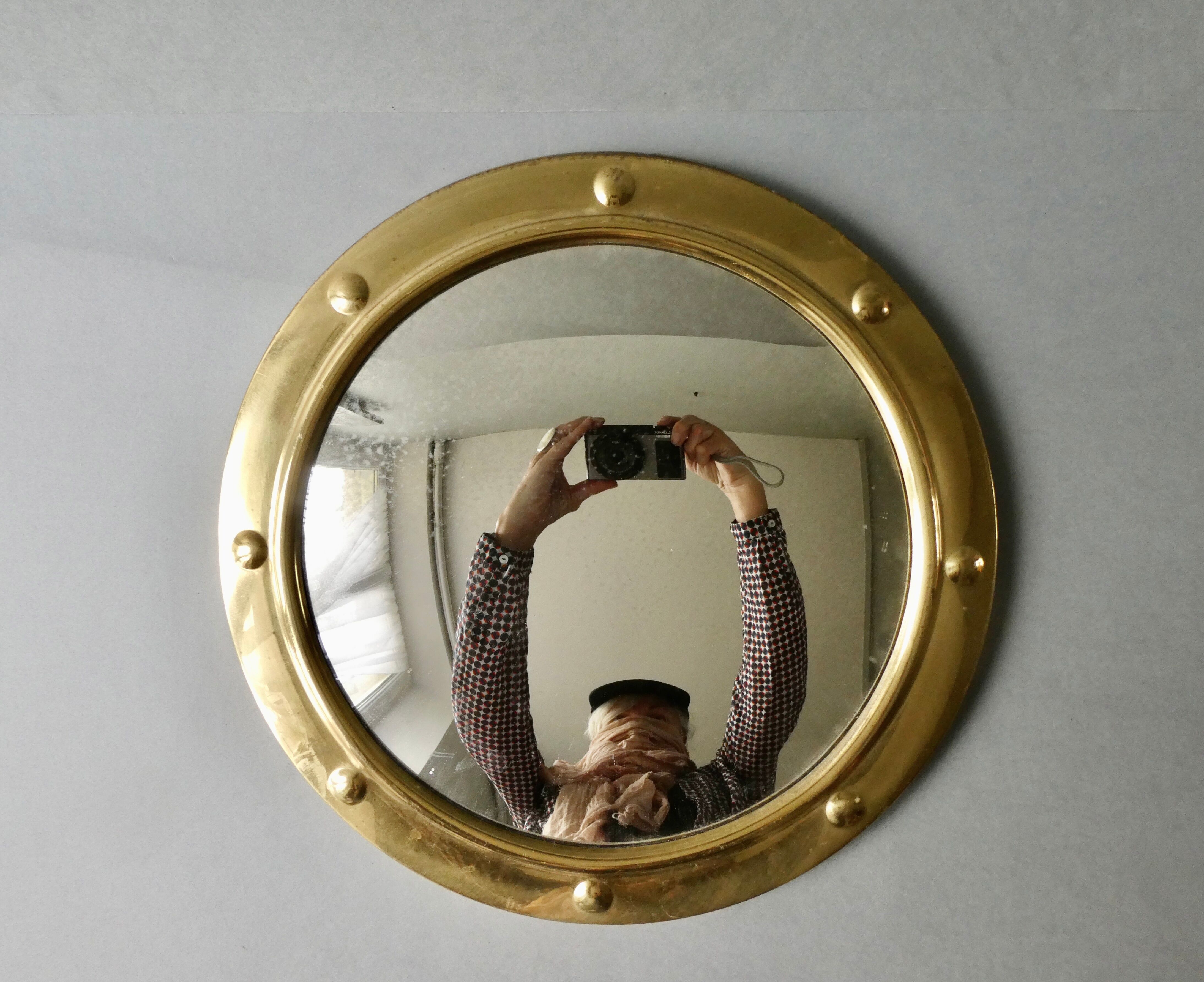 Curved mirror, in a brass porthole, 70s