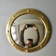 Curved mirror, in a brass porthole, 70s