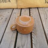 Brown sandstone cup with white spots