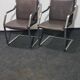One of two vintage Leather and metal arm chairs.