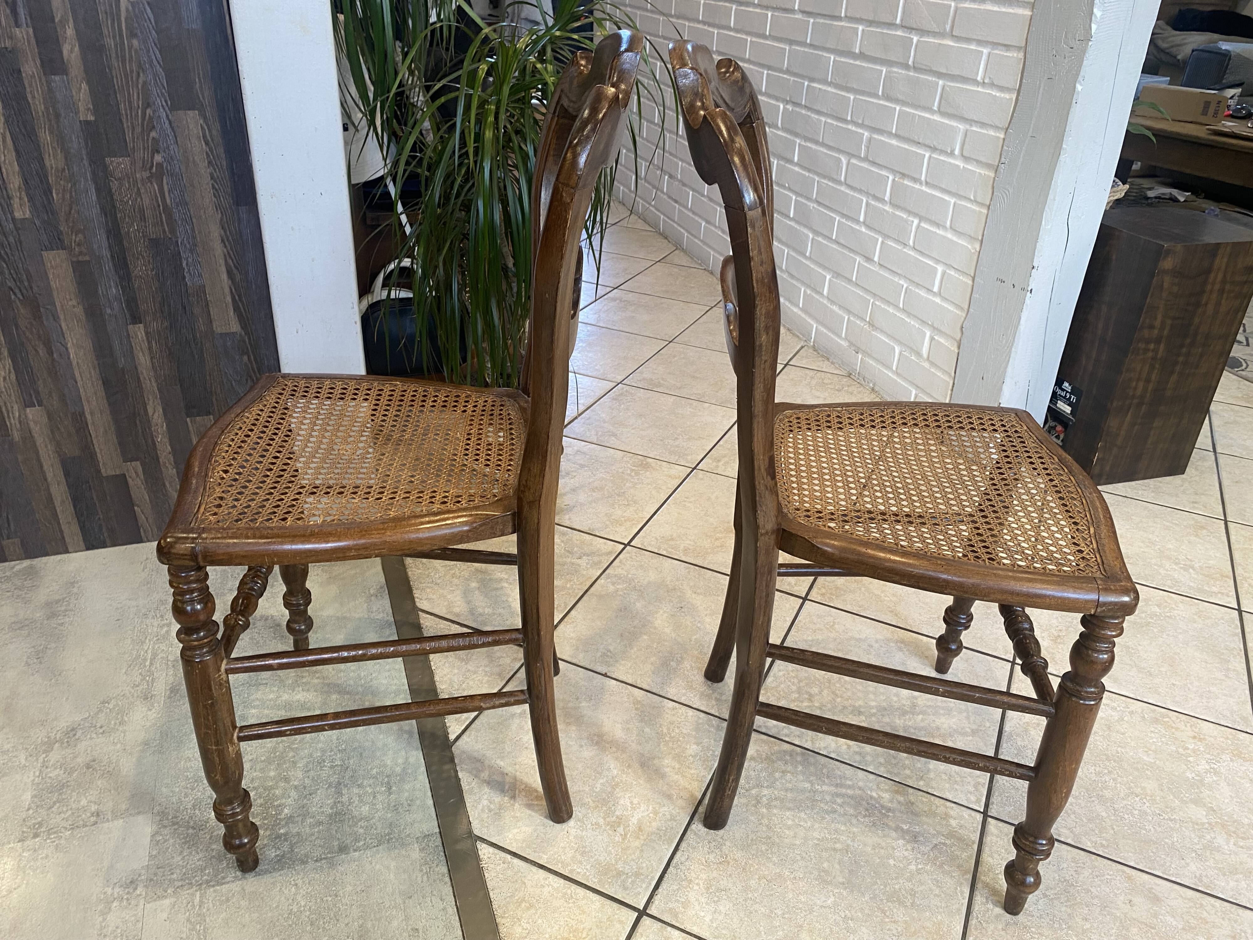 Pair of N2 antique caned and wooden chairs from the 1900s.