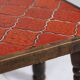 Brutalist coffee table in orange ceramic and solid wood.