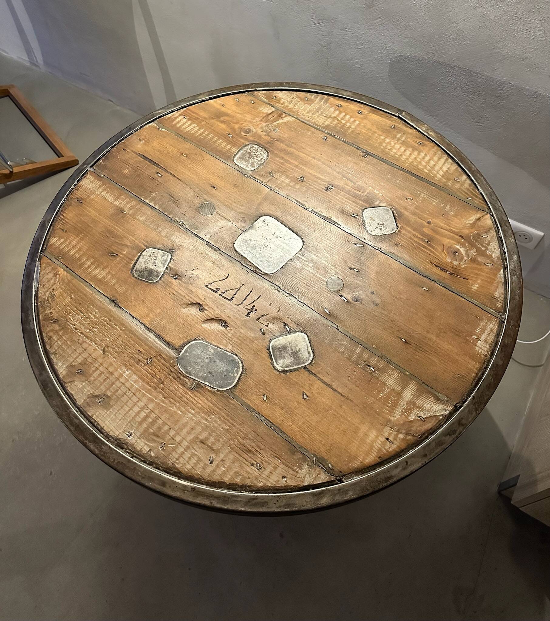 Old bistro round table / workshop – wooden top with metal rim – foot