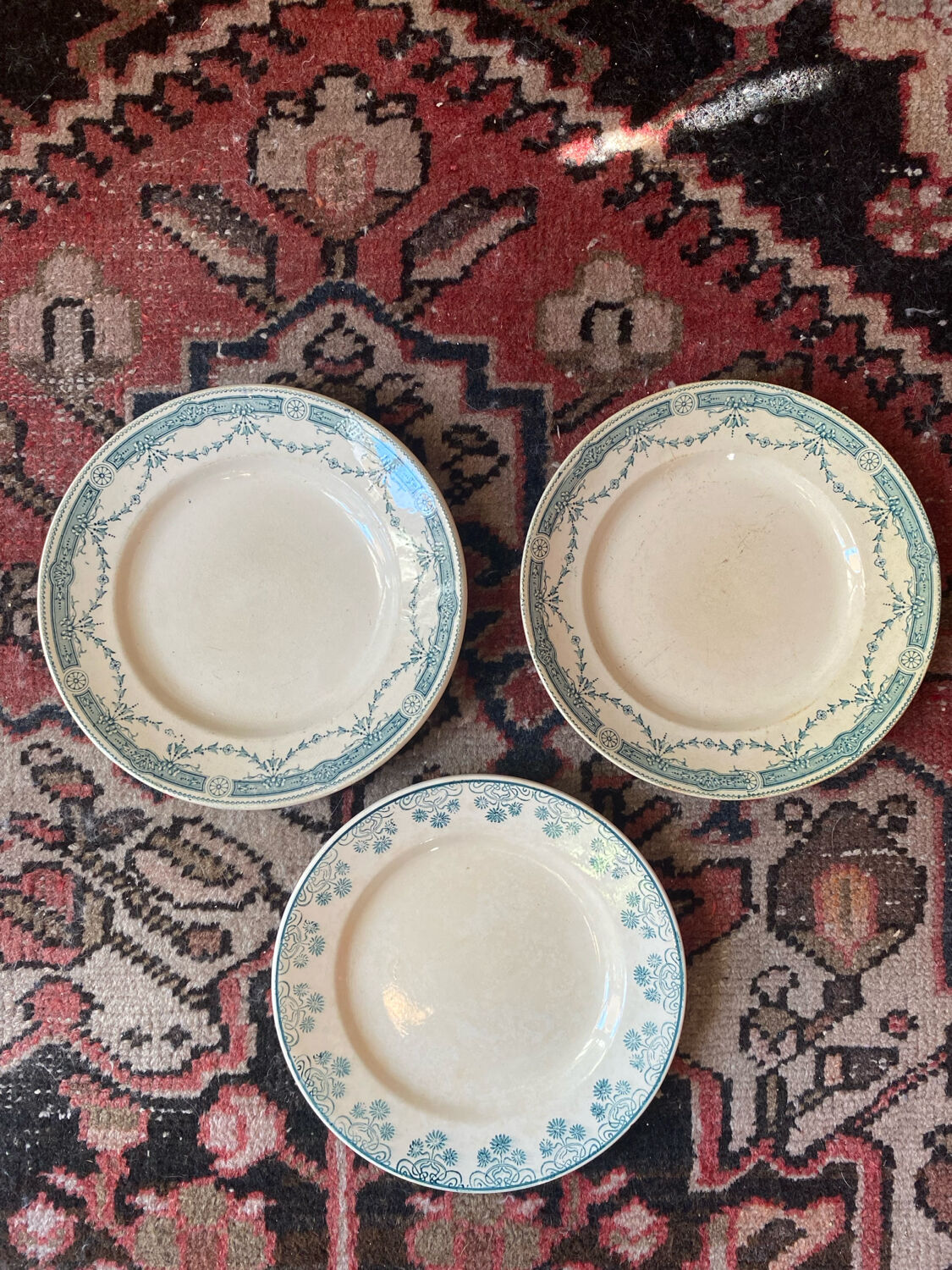 3 flat plates in ironstone with a floral green border.