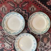 3 flat plates in ironstone with a green floral border