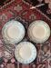 3 flat plates in ironstone with a floral green border.