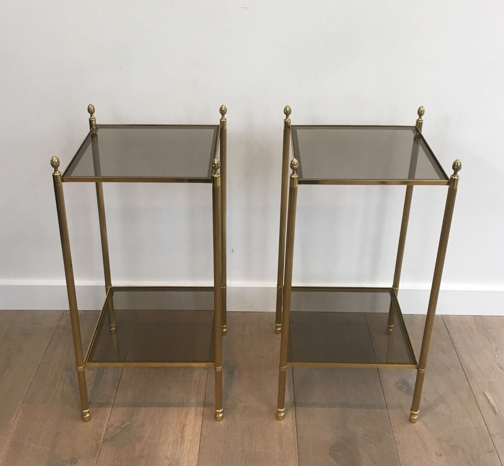 Pair of neoclassical style sofa ends in gilded metal and glass