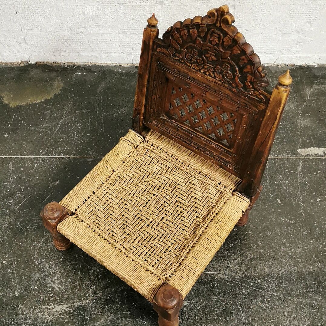 Ancient ethnic chair made of solid wood and rope
