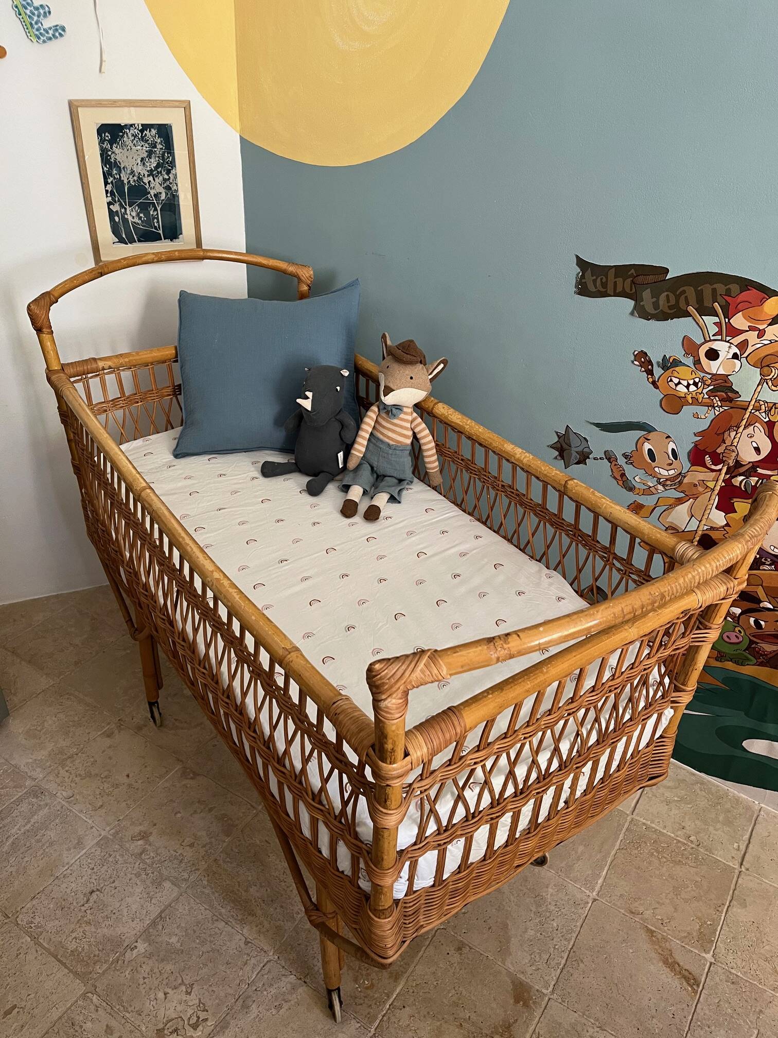 Vintage rattan baby bed with wheels