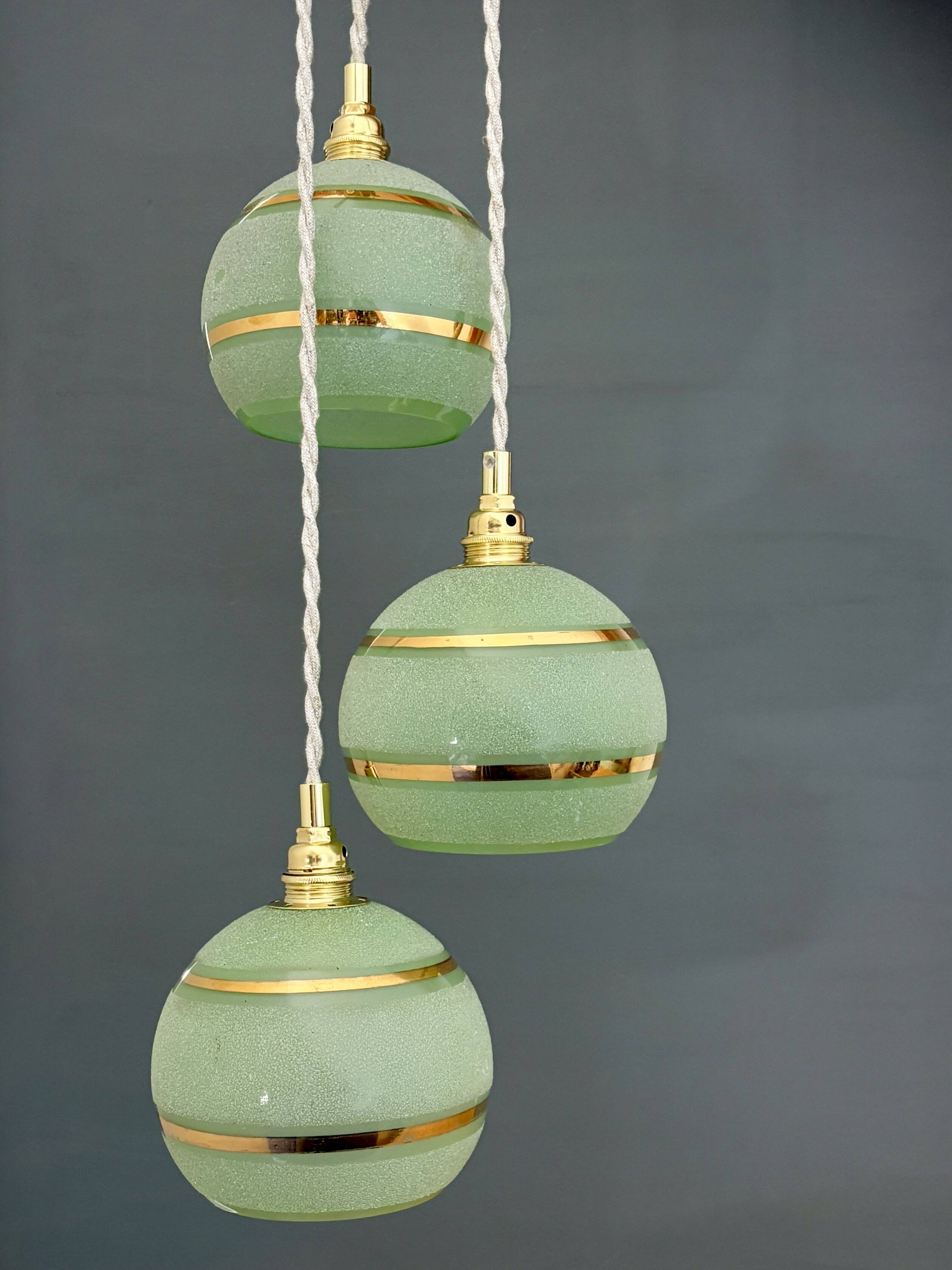 Suspension triple vintage glass globes in frosted green and gold.
