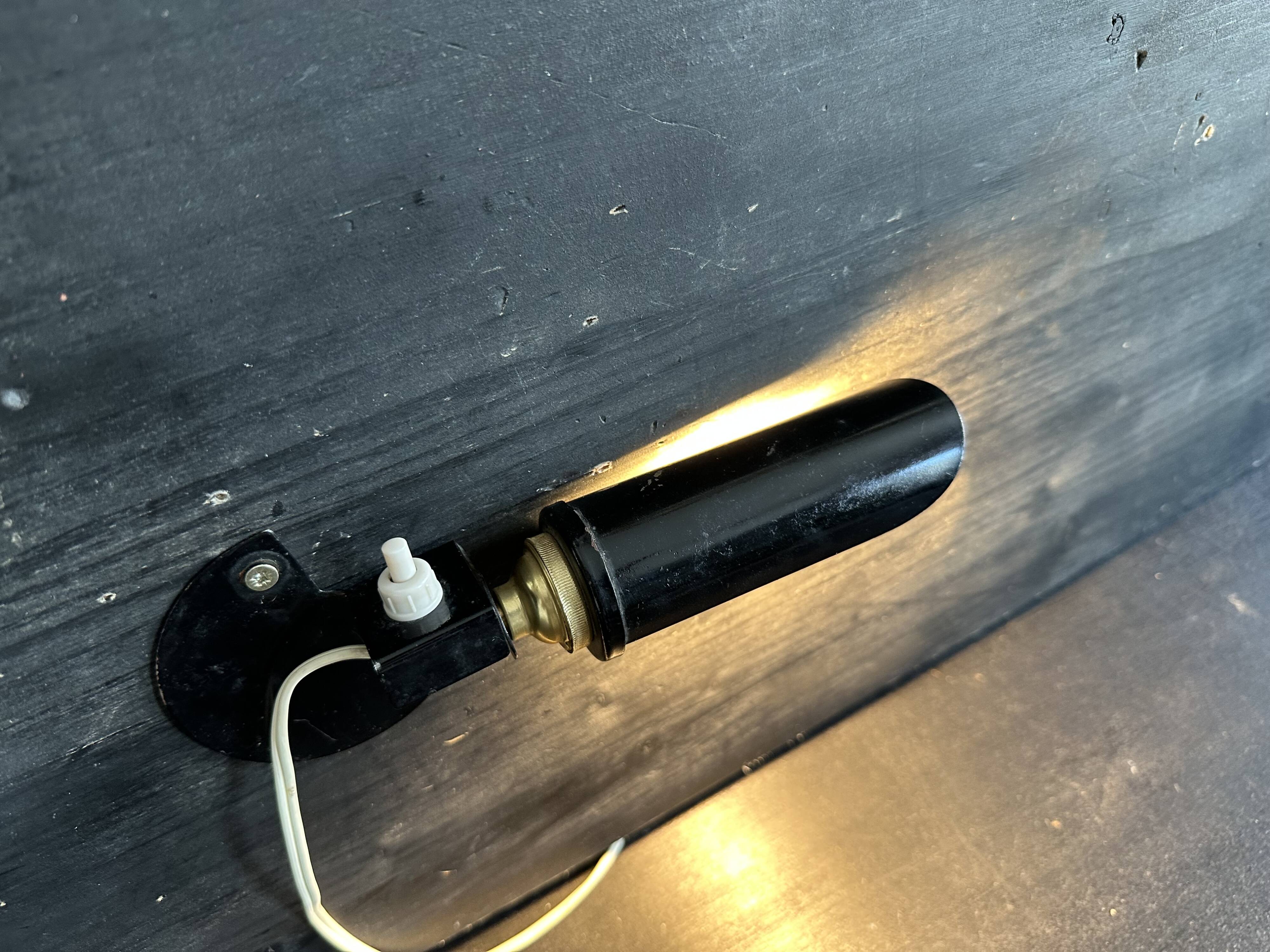 Old black metal and brass wall light, adjustable, 1930s.