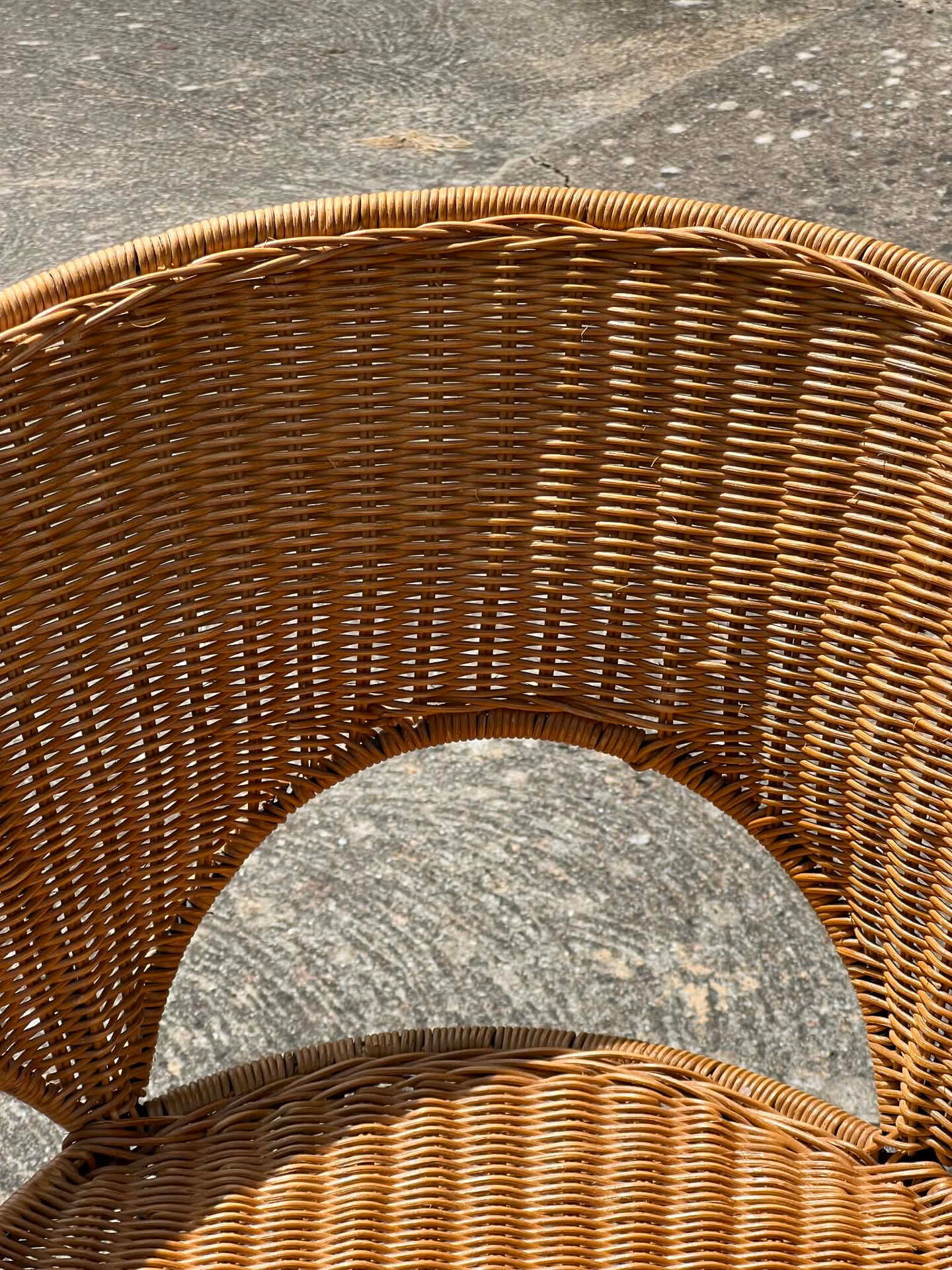 Wicker and black wrought iron armchair