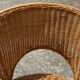 Wicker and black wrought iron armchair