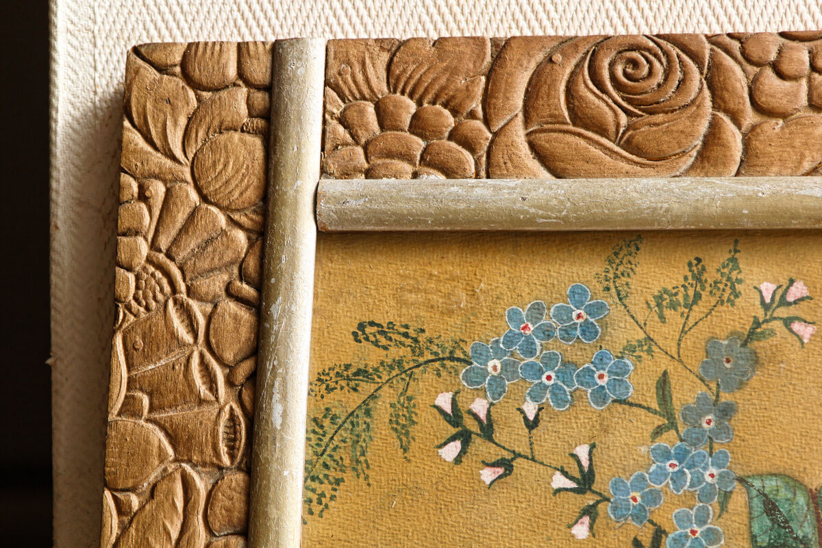 Bouquet of flowers in carved art deco frame