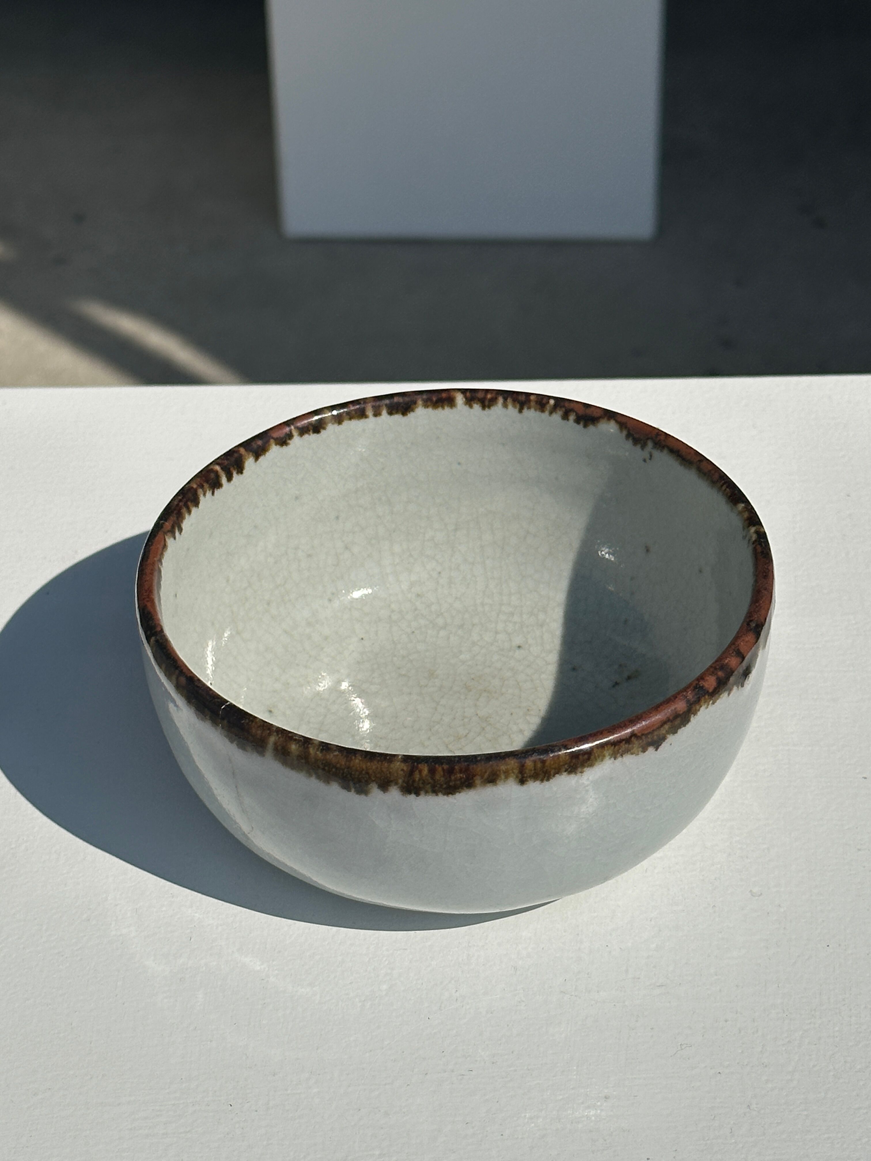 Small white glazed ceramic bowl black edges