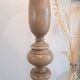 Vintage floor lamp in turned wood with an aged effect.