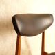 Pair of modernist Scandinavian chairs in teak and black faux leather.