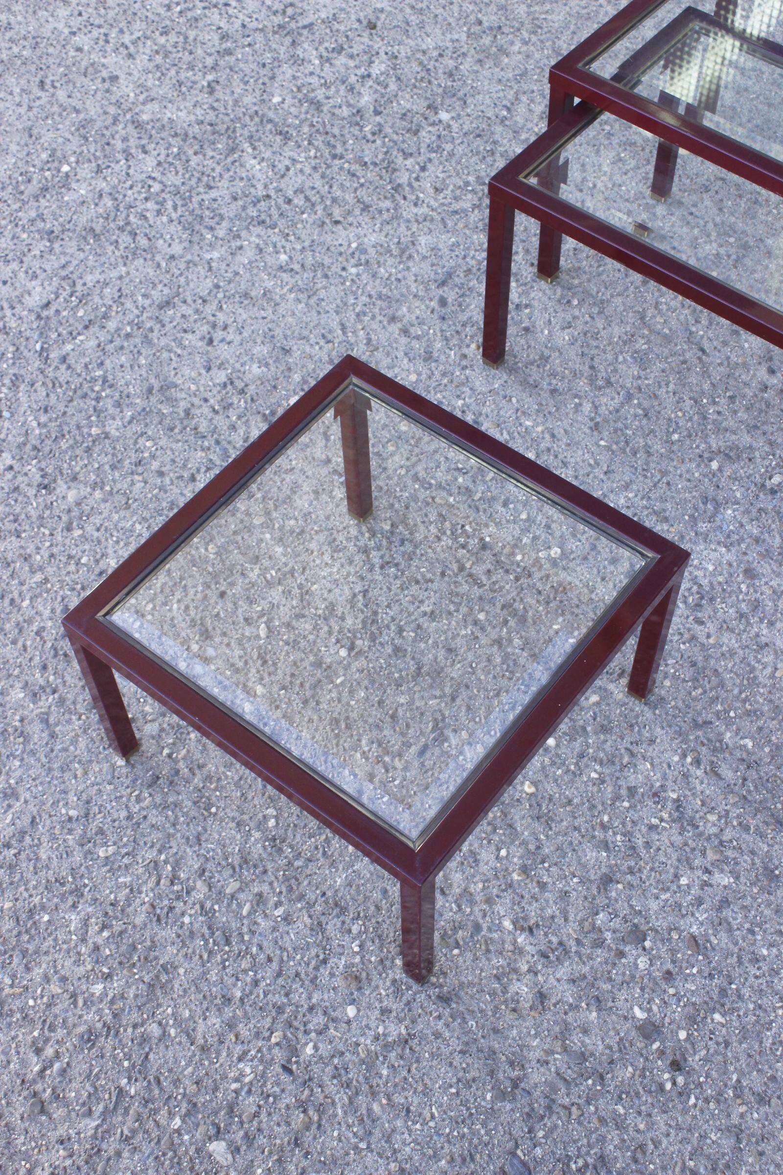 Nesting tables in burgundy lacquered metal and brass, France 1950s