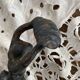 Antique cast iron coat hook with swimmer and shell basin.