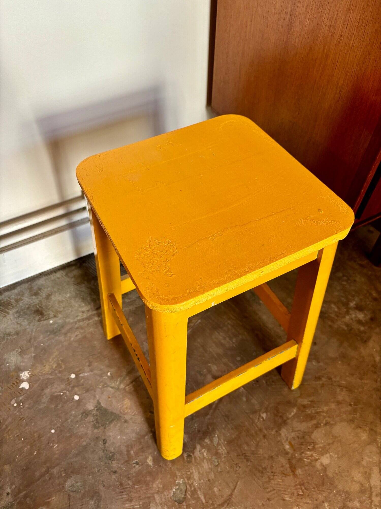 Yellow wooden stool